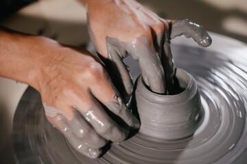 Creating a pottery piece on a wheel at an artisan studio