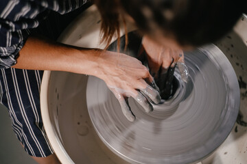 Creating pottery on a spinning wheel in a serene studio environment