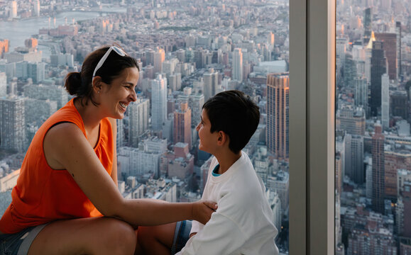Mother and son enjoying panoramic city view from NYC skyscraper