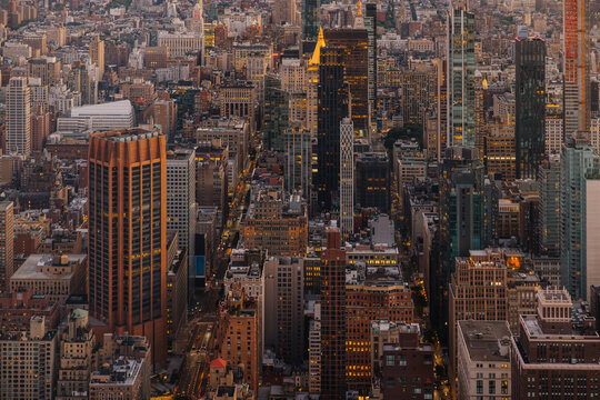 Aerial view of NYC skyline with illuminated buildings at dusk