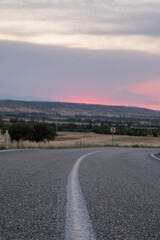 The bend of the rural road at sunset