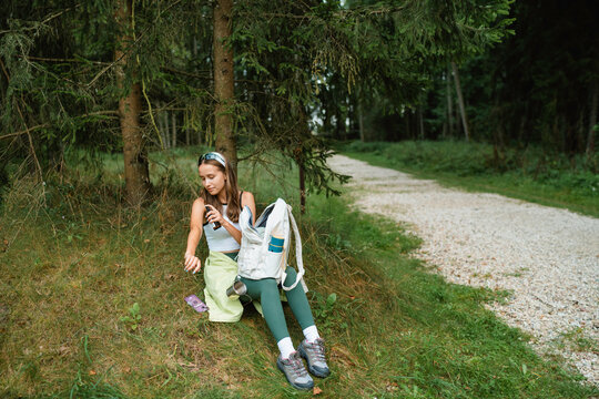 Woman sprays with mosquito repellent
