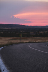 The bend of the rural road at sunset