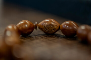 A brown bead bracelet with a hole in the middle