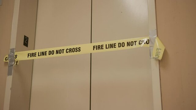 Fire Line Do Not Cross blocking off elevator in building 4k
