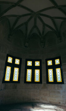 Medieval castle interior panorama with stained glass windows