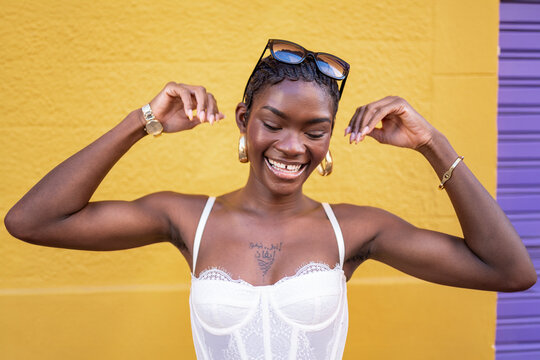 Black woman dancing and having fun against a colorful background