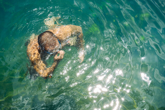 Man Swimming Underwater in Clear Blue Water