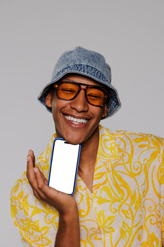 Happy man showing smartphone with blank screen