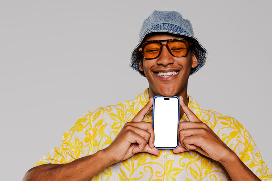 Happy man showing smartphone with blank screen