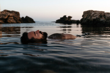 Relaxed man floating in the sea