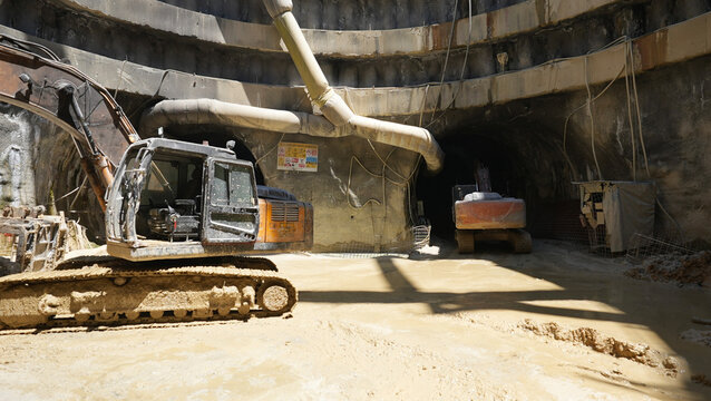 crawler excavators standing in front of tunnels
