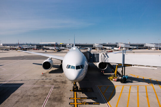 Commercial airplane docked at gate in New York JFK airport terminal