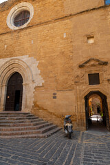 Cityscape with old historical buildings, narrow street and restaurants in Agrigento, Sicily, Italy