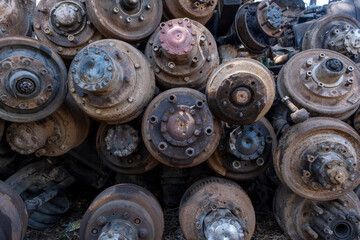 Scrapped truck axles in a scrapyard