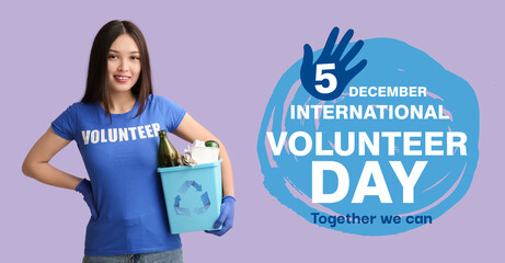 Young female volunteer holding recycle bin with garbage on lilac background