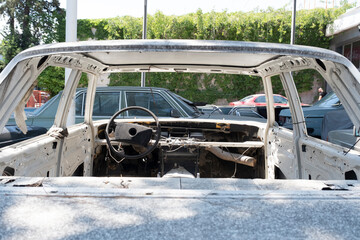 Old white car in the repair garage