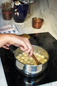 Female cook boiling Gnocchi 