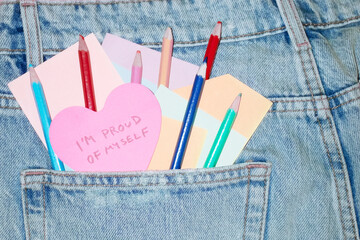 Jeans & heart post-it note saying "proud of myself" about self-love