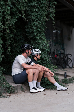 Two cyclists rest after training