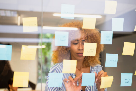 Woman organizing sticky notes during a brainstorming session