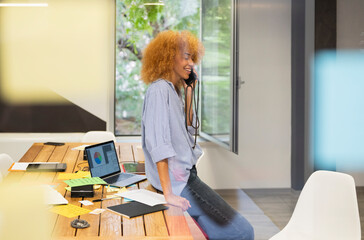 Coworker talking on the phone at office 