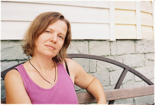 Portrait of a woman sitting on a bench