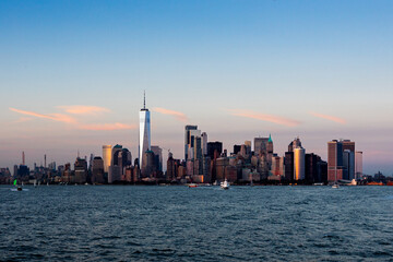 Manhattan's majestic skyscrapers bathed in glowing colors of sunset