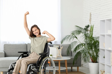 Young pretty woman in wheelchair at home