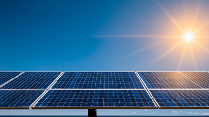 Obraz premium Solar panels reflecting sunlight under clear blue sky, showcasing renewable energy technology. bright sun enhances vibrant scene, emphasizing sustainability