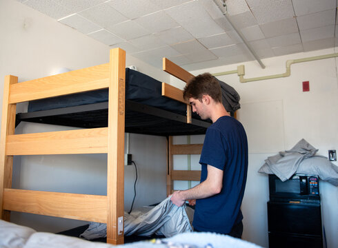 Student moves into dormitory on college campus