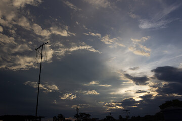 Sky with clouds and electricity pole at sunset. Nature background and wallpaper.
