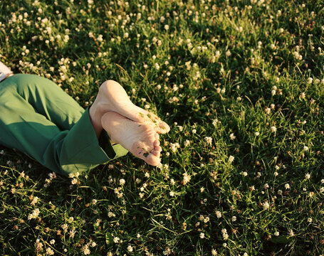 Relaxing Barefoot in a Lush Flower-Covered Meadow