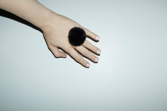 Hand with fluffy furry detail fashion ring with hard direct flashlight
