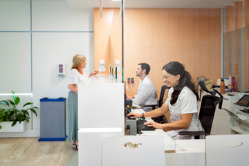 Medical staff working at hospital reception desk