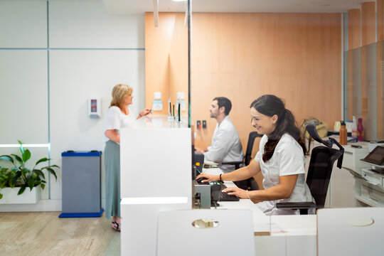 Medical staff working at hospital reception desk