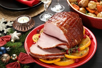 Tasty baked ham served on black wooden table