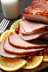 Tasty baked ham served on black table, closeup