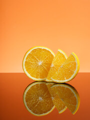 Orange fruit. Slices with reflective isolated on orange background