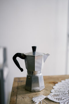 Classic stovetop espresso maker on a wooden table