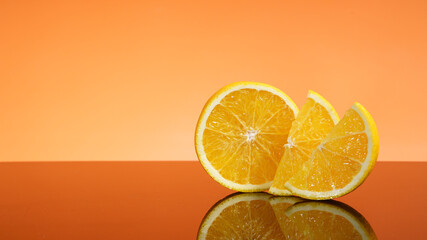 Orange fruit. Slices with reflective isolated on orange background