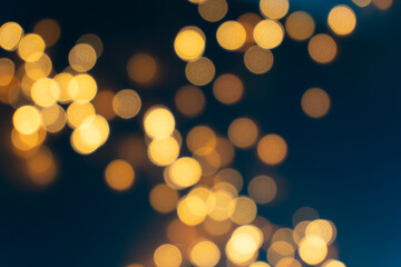 Close-up of bokeh lights from Christmas garlands, with the soft blur of glowing orbs creating a mesmerizing effect.
