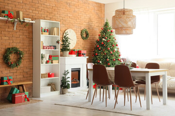 Interior of dining room with table, fireplace and Christmas trees