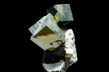 A close up of iron pyrite mineral isolated on black background.