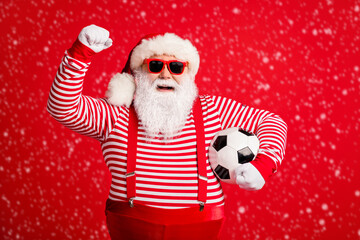 Portrait of his he nice handsome cheerful glad fat overweight Santa grandfather playing match football having fun isolated over bright vivid shine vibrant red color background