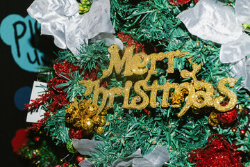 Golden Christmas sign on the tree