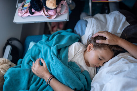 A toddler asleep on mum on an aeroplane