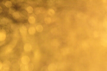 defocused abstract background of sparkling golden light.
