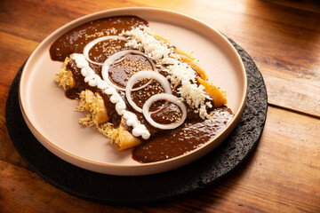 Chicken Enmoladas. In Mexico they are called Enchiladas de Mole Poblano, corn tortillas folded and filled with shredded chicken bathed in a sauce of chilies and many more ingredients called mole.