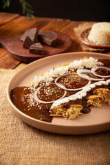 Chicken Enmoladas. In Mexico they are called Enchiladas de Mole Poblano, corn tortillas folded and filled with shredded chicken bathed in a sauce of chilies and many more ingredients called mole.